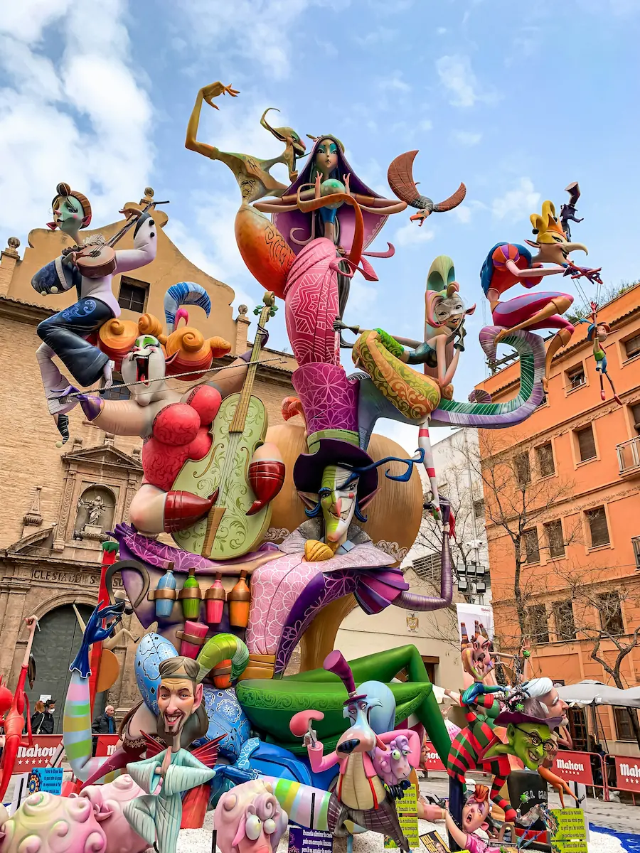 A Las Fallas monument sculpture on a Valencia street corner