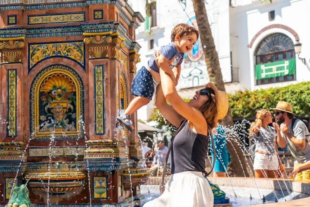 Woman and child in the central plaza of Vejer de la Frontera, Andalusia
