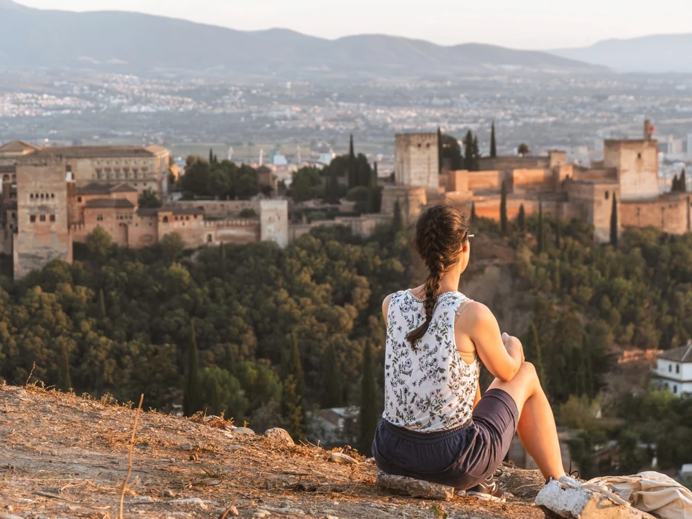 Woman looking toward the Alhambra, Granada, Andalusia